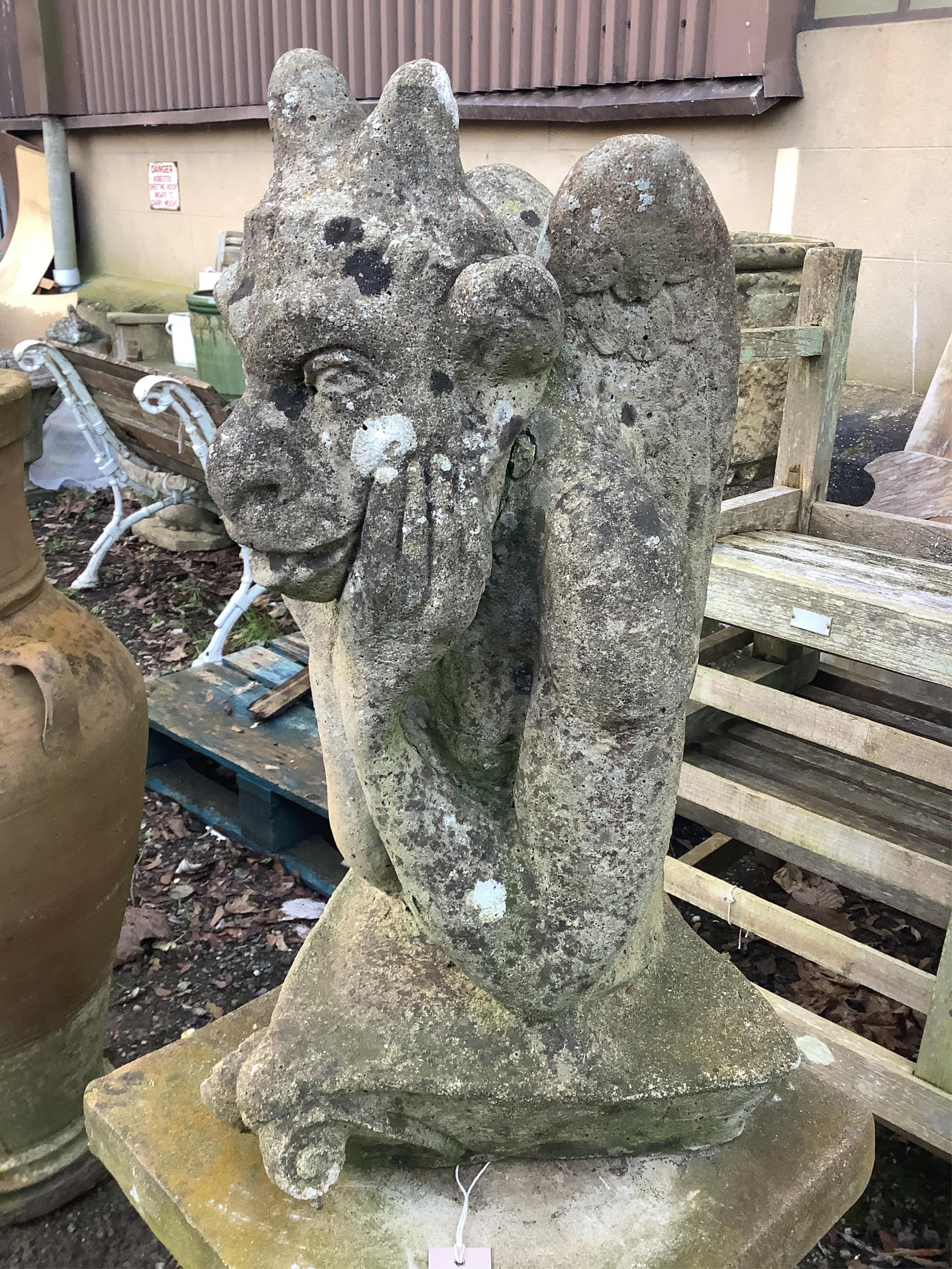 A reconstituted stone gargoyle ornament on square plinth, height 120cm. Condition - fair